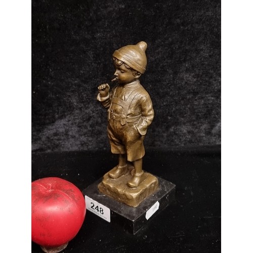 952 - Star Lot : A solid bronze figurine, expertly crafted to depict a smoking young boy in traditional at... 