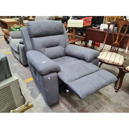 409 - Star Lot : A stylish excellent recliner armchair in a charcoal grey leather finish. €1800 less than ... 