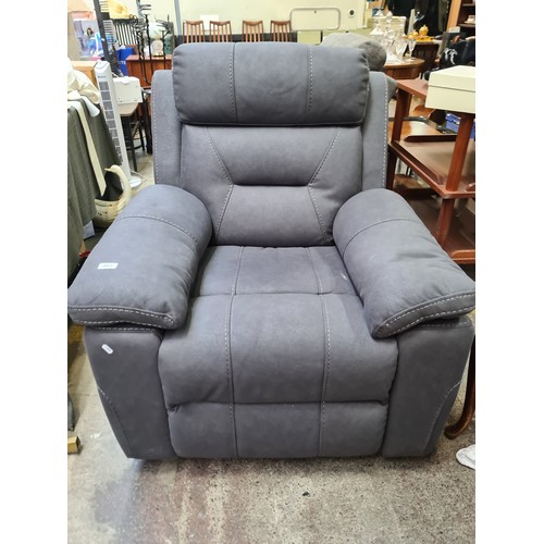 409 - Star Lot : A stylish excellent recliner armchair in a charcoal grey leather finish. €1800 less than ... 