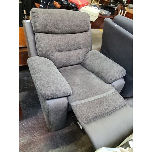 407 - Star Lot : A leather and fabric comfortable recliner armchair in a charcoal grey finish. This is in ... 