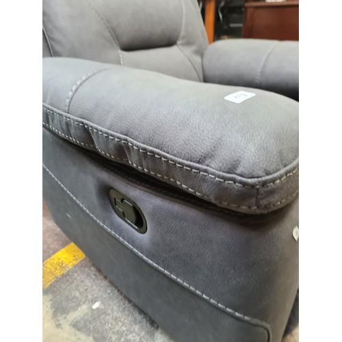 409 - Star Lot : A stylish excellent recliner armchair in a charcoal grey leather finish. €1800 less than ... 