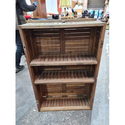 939 - A large wooden display shelving unit with two shelves. Comes with  detachable foldable support. Indo... 