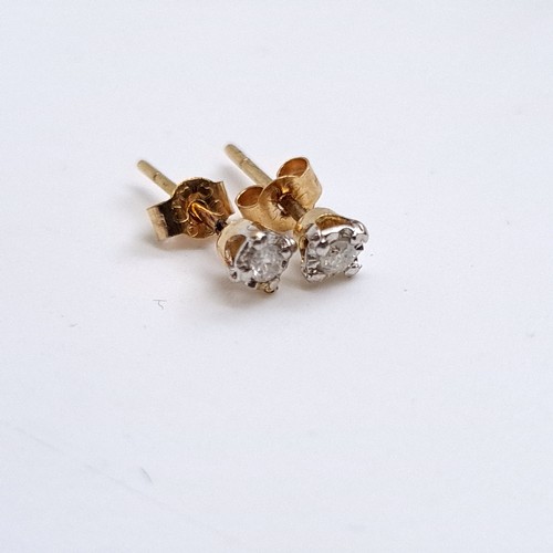 24 - Star Lot: A pair of 9K gold solitaire diamond stud earrings. Comined diamond weight approx 0.30cts )... 