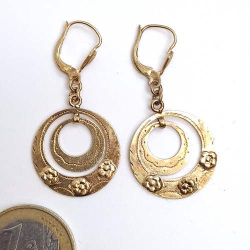 25 - Star Lot : A most attractive pair of hallmarked 9ct gold earrings with articulated disc mounts suita... 