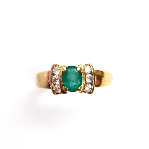 26 - Star Lot : A beautiful 18K emerald stone set diamond ring with wide band shoulders, ring size J, wei... 