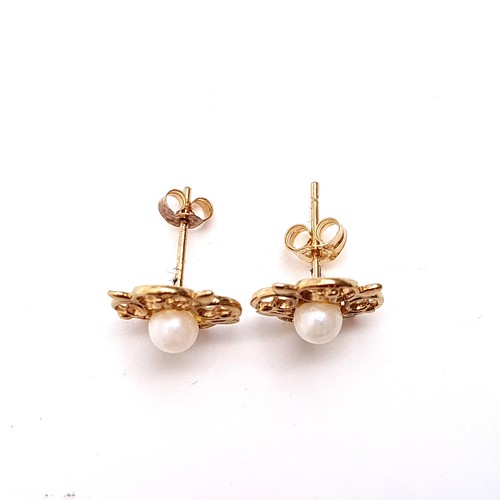 28 - A pair of vintage pearl set 9K gold stud earrings with scroll design mounts, weight 1.14 grams. Boxe... 