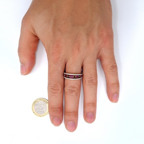 44 - Star Lot : A very handsome heavy top quality  18K gold wide band ring, set with beautiful rubies wit... 