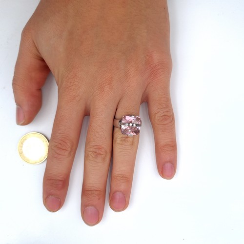 533 - A sterling silver pink facet cut gem stone ring with gem stone detailing, size M, weight 7.10 grams.... 