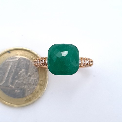 534 - A gold unmarked, green stone ring with gem set shoulders, ring band marked 750, size H, weight 3.88 ... 