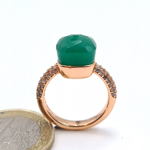 534 - A gold unmarked, green stone ring with gem set shoulders, ring band marked 750, size H, weight 3.88 ... 