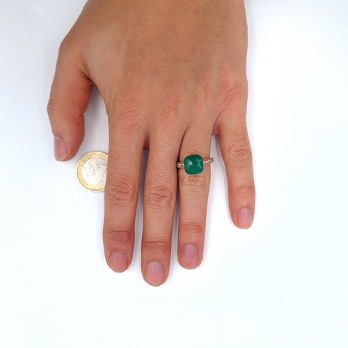 534 - A gold unmarked, green stone ring with gem set shoulders, ring band marked 750, size H, weight 3.88 ... 