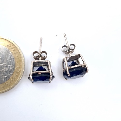 536 - A pair of blue gem set stud earrings, marked 925 sterling silver, weight 2.77 grams. Boxed.