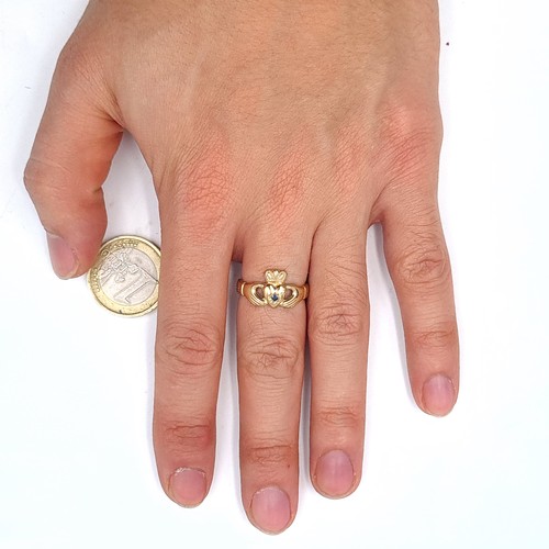 543 - A nice example of a 9K gold  gem set claddagh ring, size N, weight 3.18 grams. Boxed.