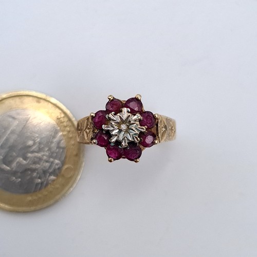 588 - Star lot : A super fine example of a 9K gold diamond and ruby floral set ring on a crown raised moun... 