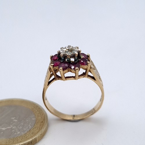 588 - Star lot : A super fine example of a 9K gold diamond and ruby floral set ring on a crown raised moun... 