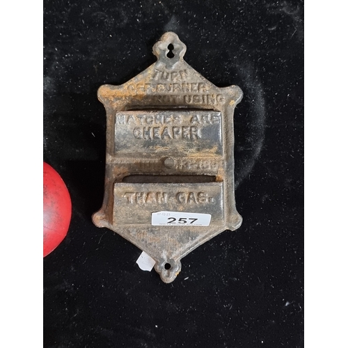 257 - A cast iron match holder with text 