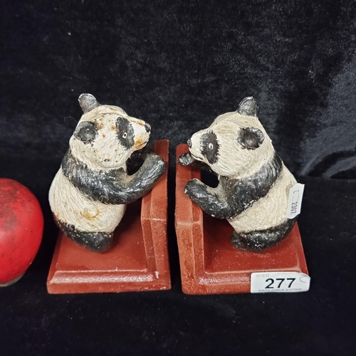 277 - Charming heavy cast metal bookends, featuring whimsical painted panda figures, perched upon sturdy r... 