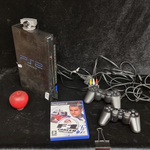 279 - A Sony PlayStation 2 console with accessories, including controllers and an F1 game.