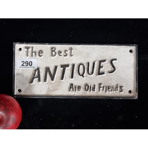 290 - A timeless cast-metal wall sign, inscribed with 'The Best ANTIQUES Are Old Friends,'