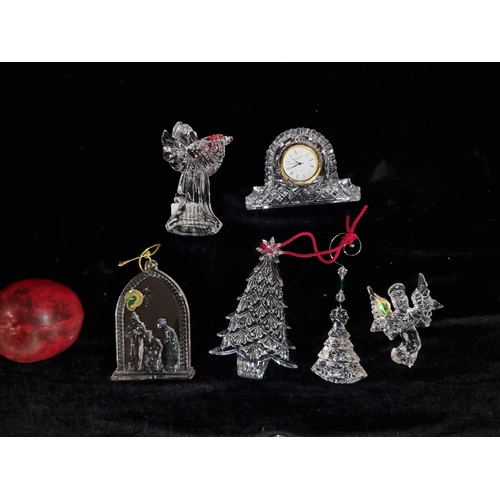 296 - A intricate collection of Waterford Crystal Christmas ornaments, featuring a clock and angelic figur... 