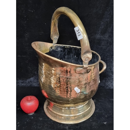 313 - A handsome vintage brass coal scuttle, featuring a hammered finish and carrying handle, evoking earl... 