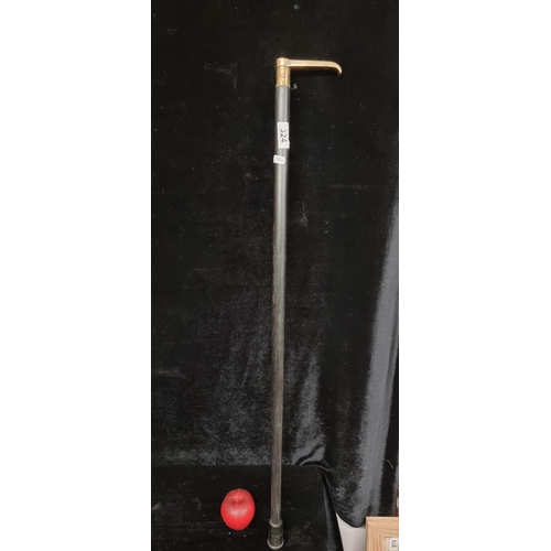 324 - A timeless ebony wood, brass-handled walking stick featuring a brass compass to top.