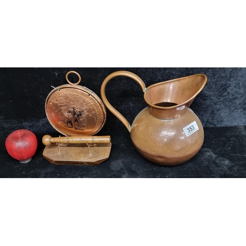 353 - Two copper items including a vintage pitcher along with a dinner gong boasting an elephant motif and... 