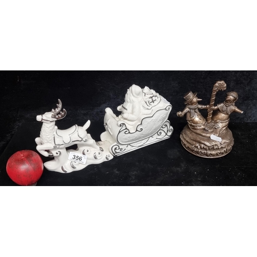 356 - Two cheerful Christmas items including a ceramic 
Newbridge figure of Santa in his reindeer-pulled s... 