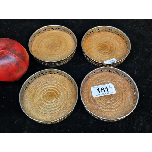 181 - A lovely set of four vintage English made wine coasters with wooden turned bases and pierced silver ... 