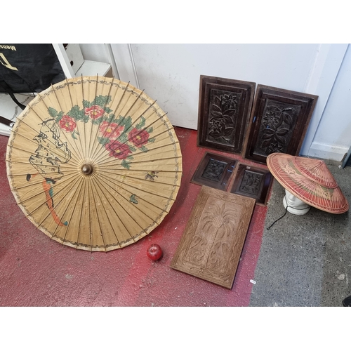 207 - A collection of vintage Chinese items including four hand carved wall plaques, a parasol and a sun h... 