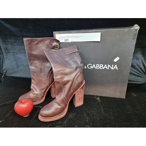 227 - Star Lot: A super stylish pair of Dolce & Gabbana heeled boots in a maroon finish with brass buckle ... 