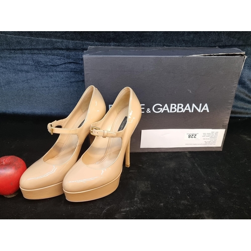 228 - Star Lot: A timeless pair of Dolce & Gabbana genuine leather platform heels in a glossy beige finish... 