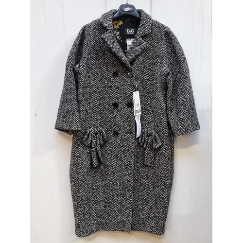 235 - Star Lot - A fabulous ladies Dolce & Gabbana coat finished with wool blend herringbone motif fabric,... 