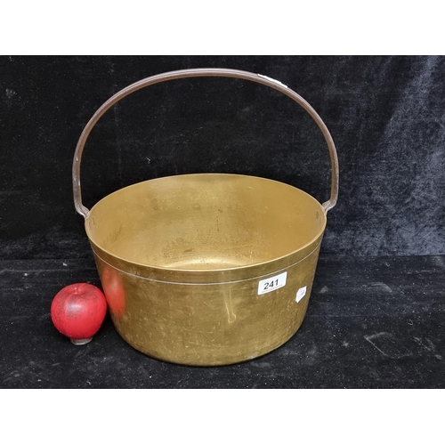 241 - A large antique heavy Victorian brass preserving pot ingot condition with swing handle.