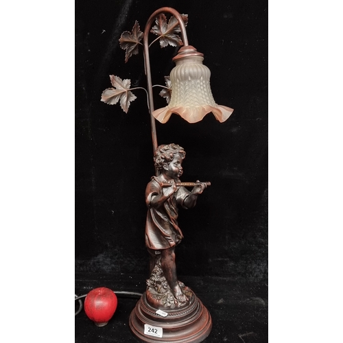 242 - A large decorative table lamp in the form of a child with a glass shade.