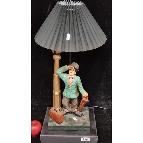 244 - A large whimsical Charlie Chaplin table lamp with pleated shade.