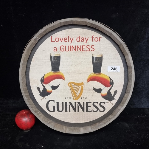 246 - A large Guinness advertising wall sign in the form of a whiskey barrel top.