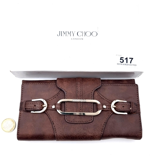 517 - A designer as new boxed Jimmy Choo leather wallet, featuring lovely belt detail and interior compart... 