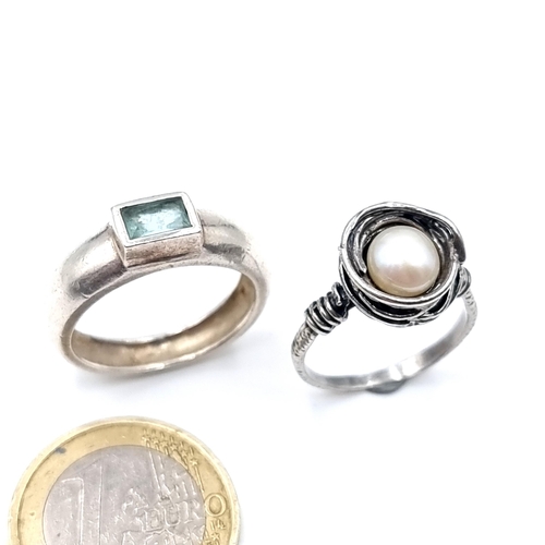 519 - Two silver rings including one with a pearl setting (stamped 925, ring size O) along with a hand mad... 