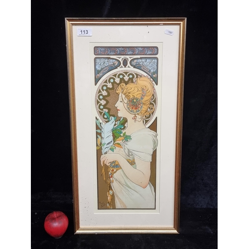 113 - A vintage print of a Mucha painting titled Primrose and Feather. Housed in a gilt frame behind glass... 