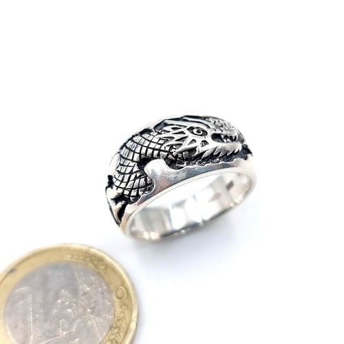 550 - A sterling silver gents hallmarked ring with dragon incised, ring size S, weight 6.97 grams, boxed.