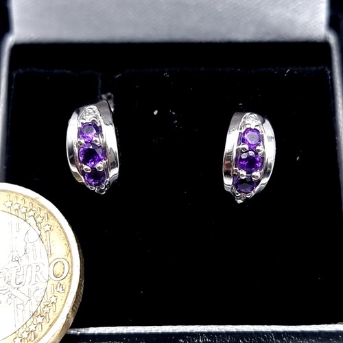 557 - Star lot : A stunning pair of 9K white gold marked to posts Diamond and amethyst stud earrings, weig... 