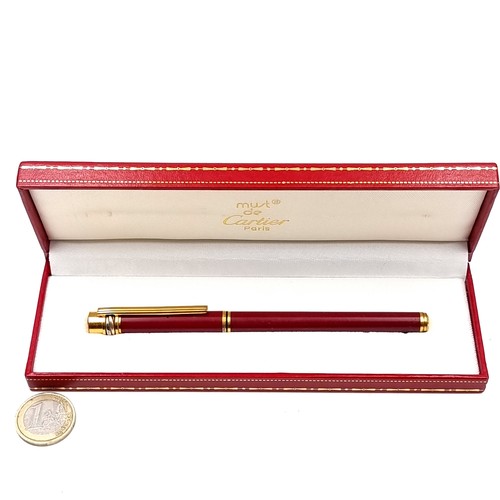 560 - Star Lot : A must de Cartier Paris trinity fountain pen set with a red bodied finish with gold metal... 