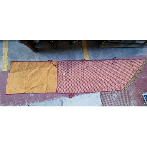 574 - A large and long heraldic banner finished with a fringe trim and featuring a tactile red and orange ... 