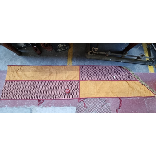 577 - A large and long heraldic banner finished with a fringe trim and featuring a tactile red and orange ... 