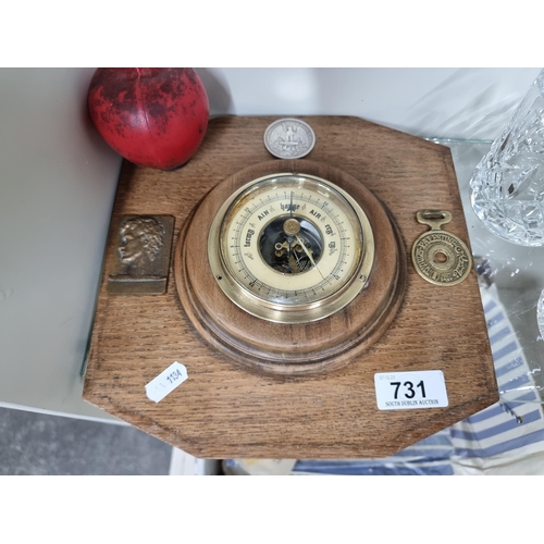 731 - A fine example of a vintage  wall aneroid barometer featuring an American one dollar coin and a Pale... 