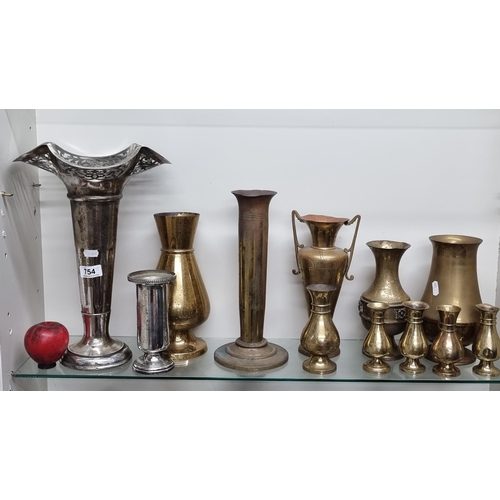 754 - A large selection of twelve brass and metal items including a large trumpet vase.