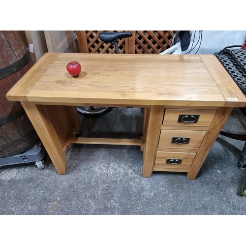 694 - A well made solid oak desk with three drawers to side, each boasting cast drop handles and construct... 