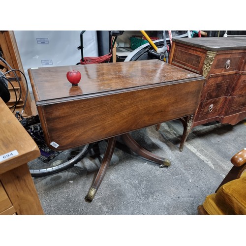 698 - Star Lot: A very handsome Edwardian drop leaf mahogany table held on a central pedestal ending in fo... 