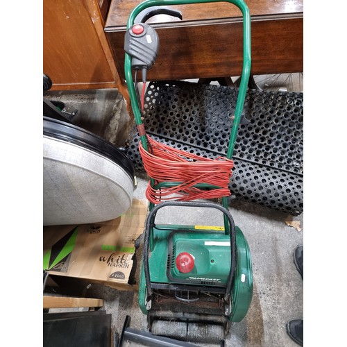 699 - A Qualcast putting green lawn mower. Made in the UK. With three pin plug.